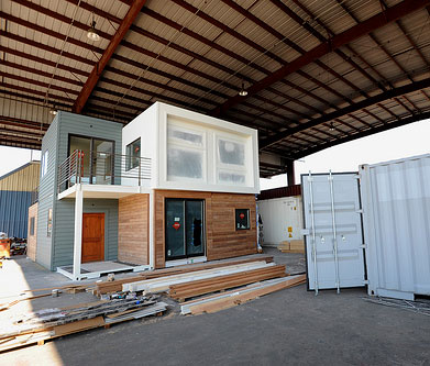 Constructing a kit home under cover in a warehouse.  You need a pretty big warehouse for this!  Image from Photopin.com.